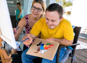 A man and a woman painting on a canvas. A man and a woman painting on a canvas.